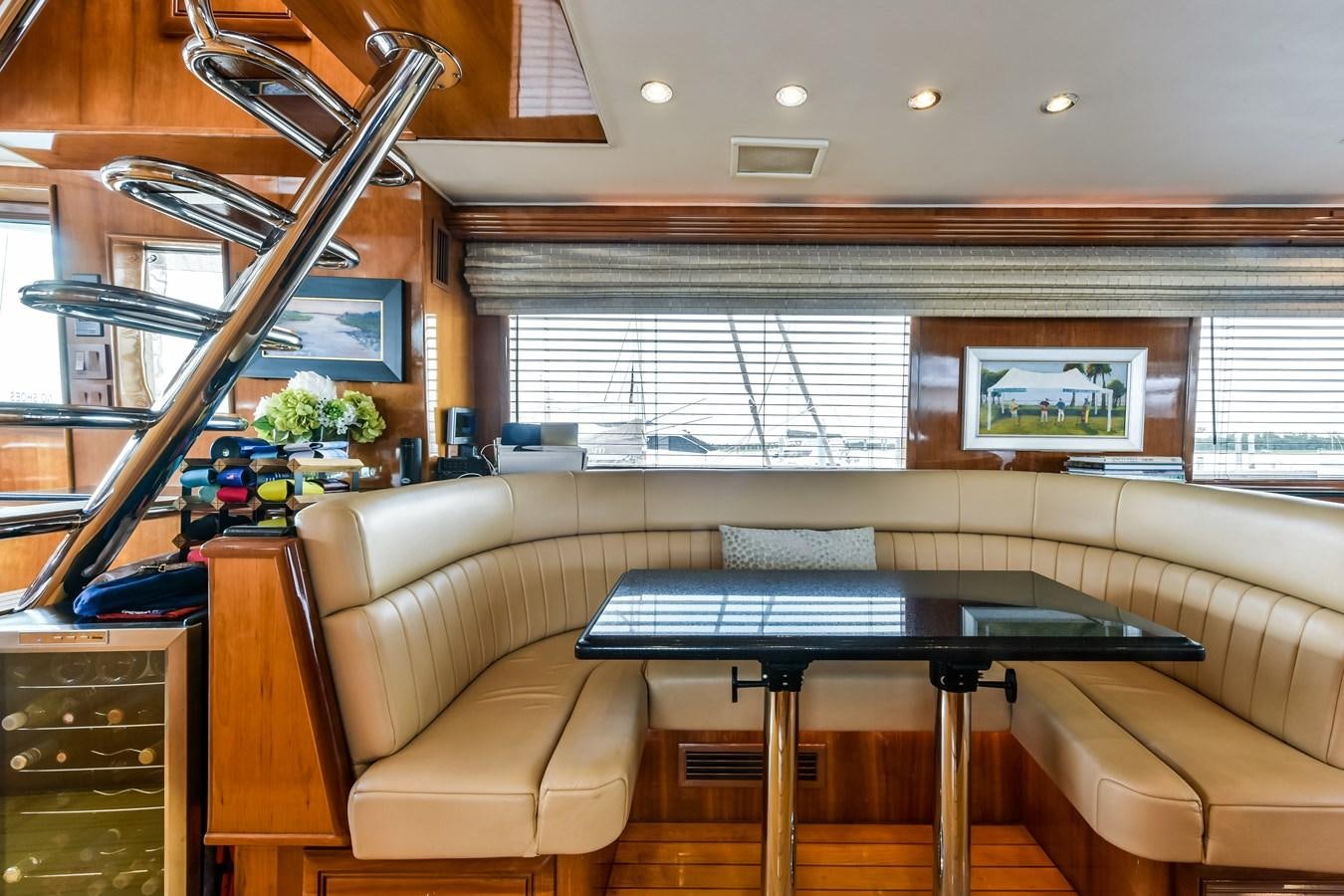 a room with a table and couches aboard BOOGIE BABE III Yacht for Sale
