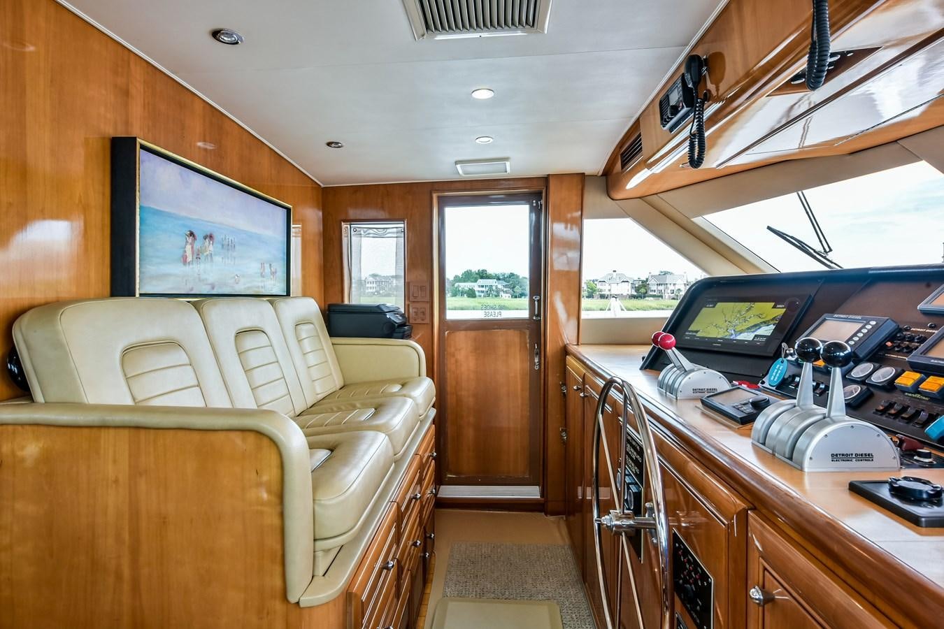 a room with a couch and a television in it aboard BOOGIE BABE III Yacht for Sale