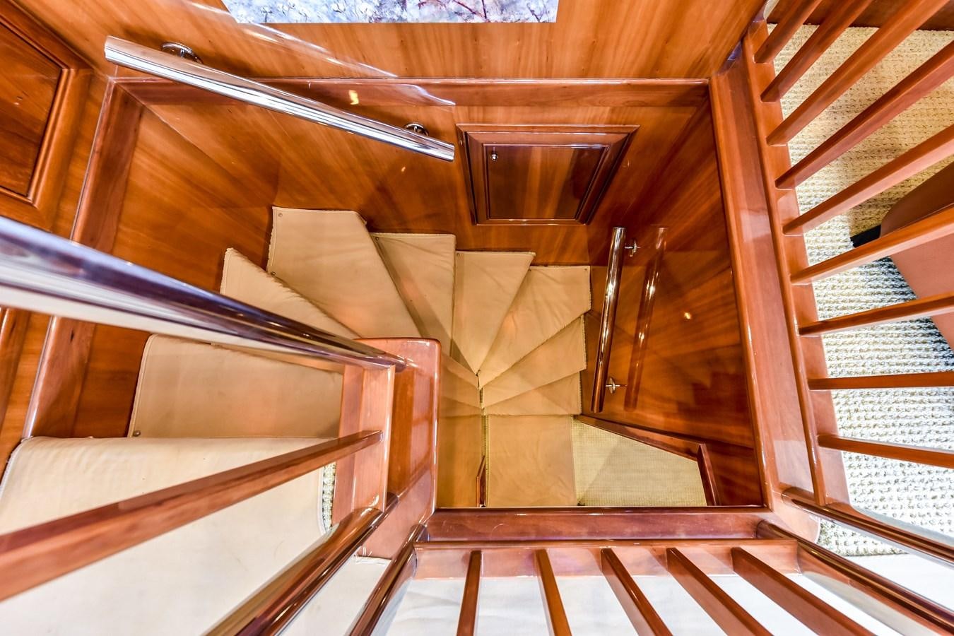 a wooden staircase with wooden walls aboard BOOGIE BABE III Yacht for Sale