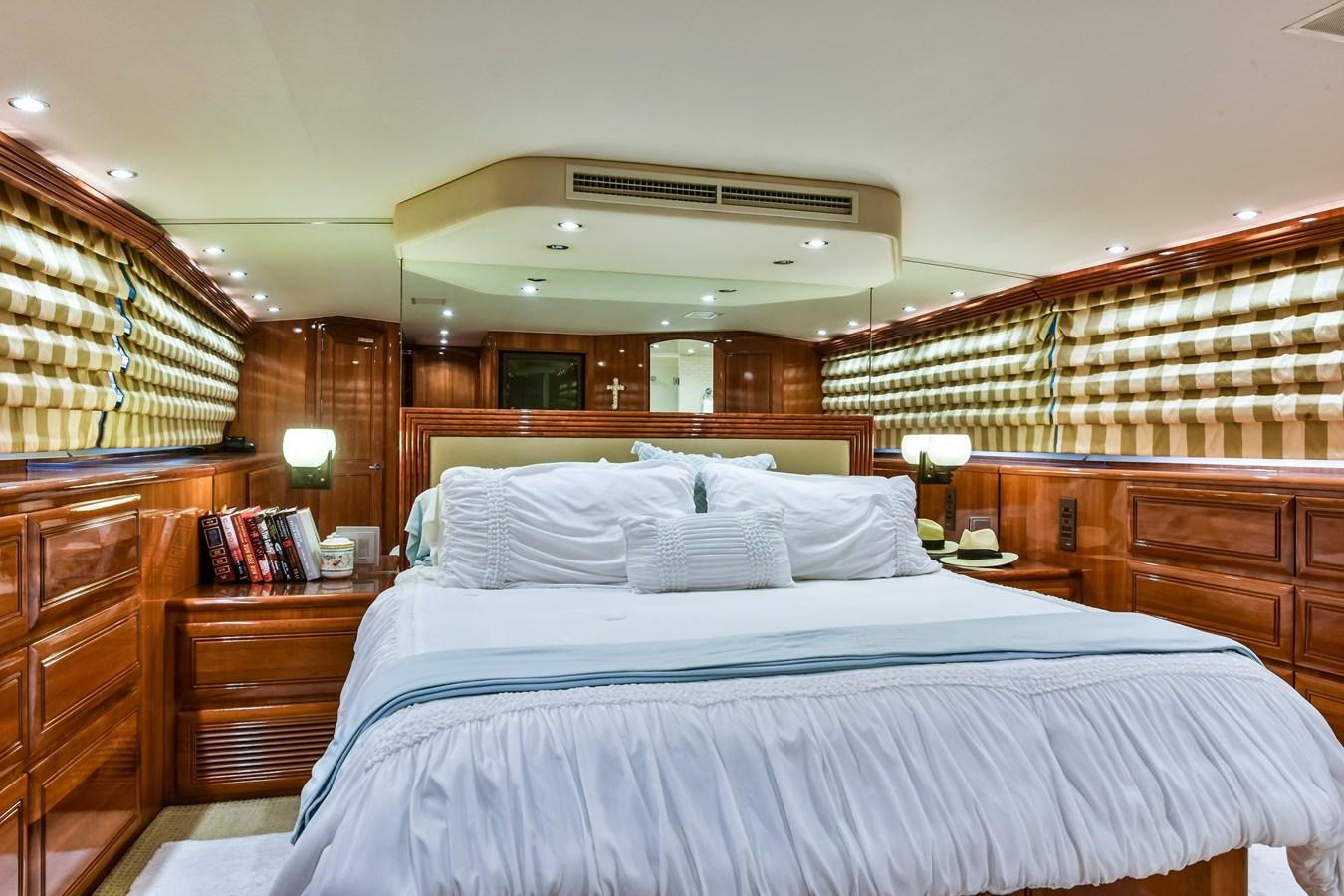 a bedroom with a bed and a wood wall aboard BOOGIE BABE III Yacht for Sale