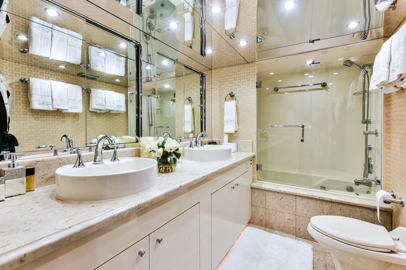 a bathroom with a large mirror aboard BOOGIE BABE III Yacht for Sale