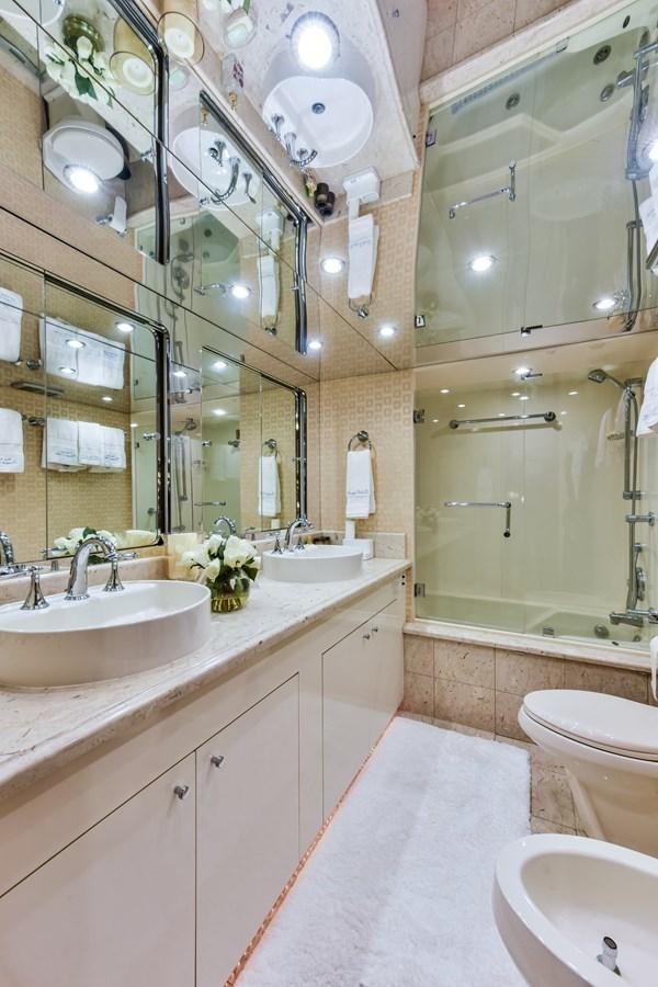 a bathroom with a large mirror aboard BOOGIE BABE III Yacht for Sale