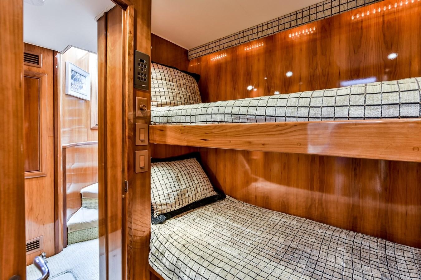a bed with a wood frame aboard BOOGIE BABE III Yacht for Sale