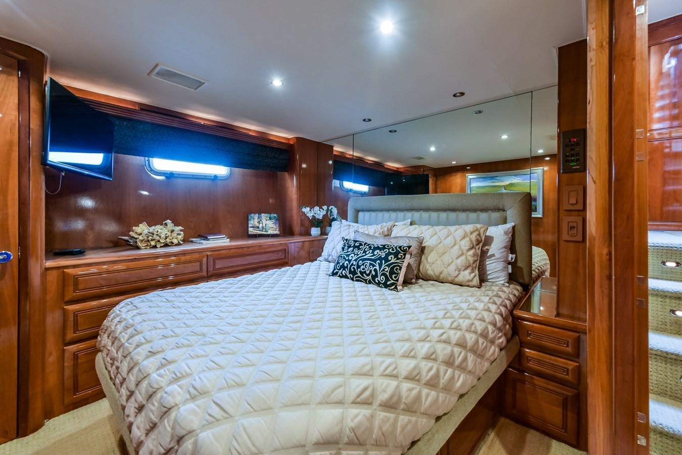 a bedroom with a large bed aboard BOOGIE BABE III Yacht for Sale