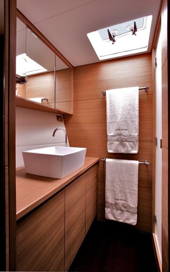 a bathroom with a sink and a mirror aboard INDIO Yacht for Sale
