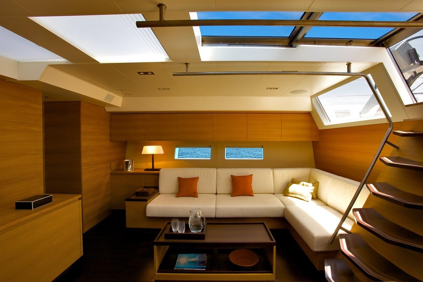 a room with a couch and a table aboard INDIO Yacht for Sale