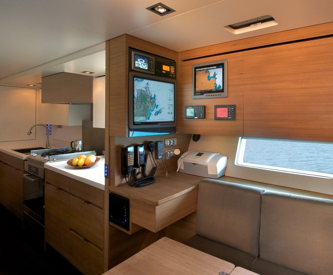 a living room with a tv and a couch aboard INDIO Yacht for Sale