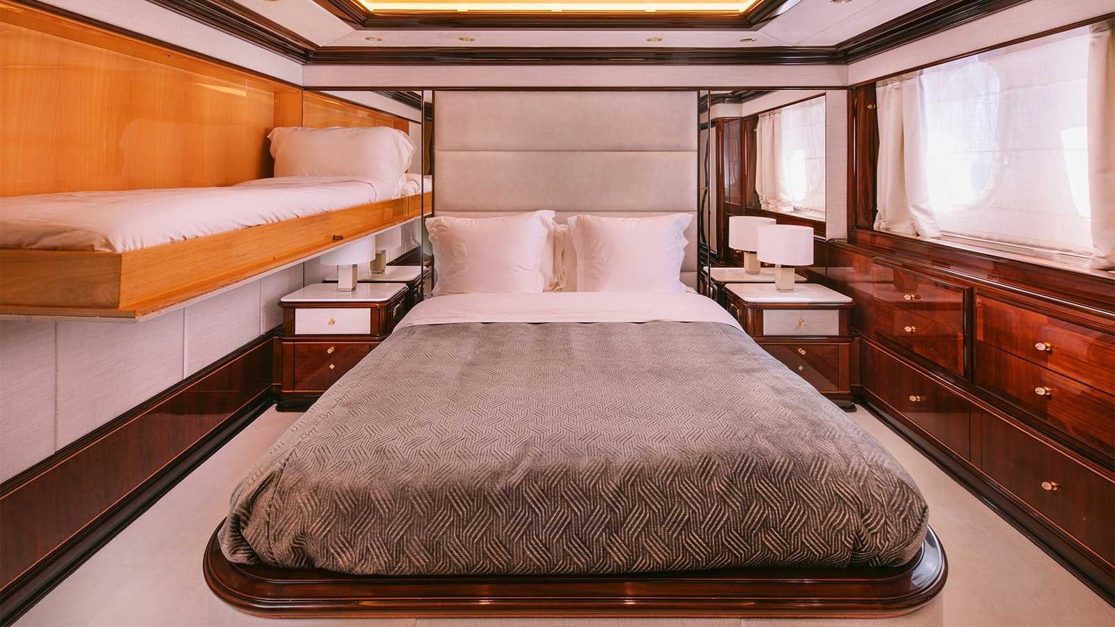 a room with a bed and a window aboard IDYLLIC Yacht for Charter