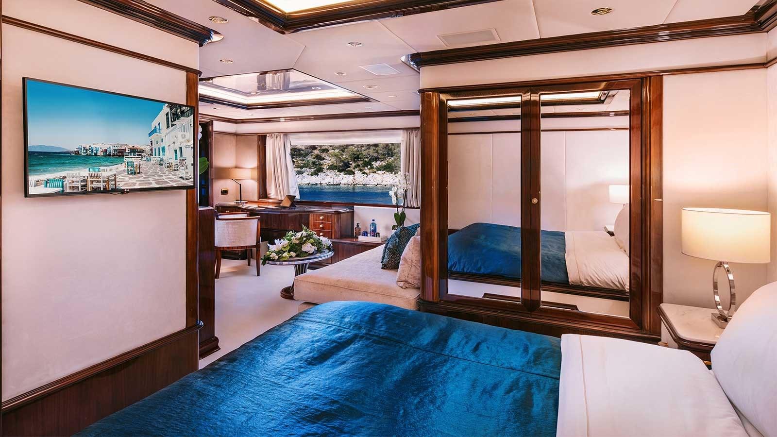 a bedroom with a large mirror aboard IDYLLIC Yacht for Charter