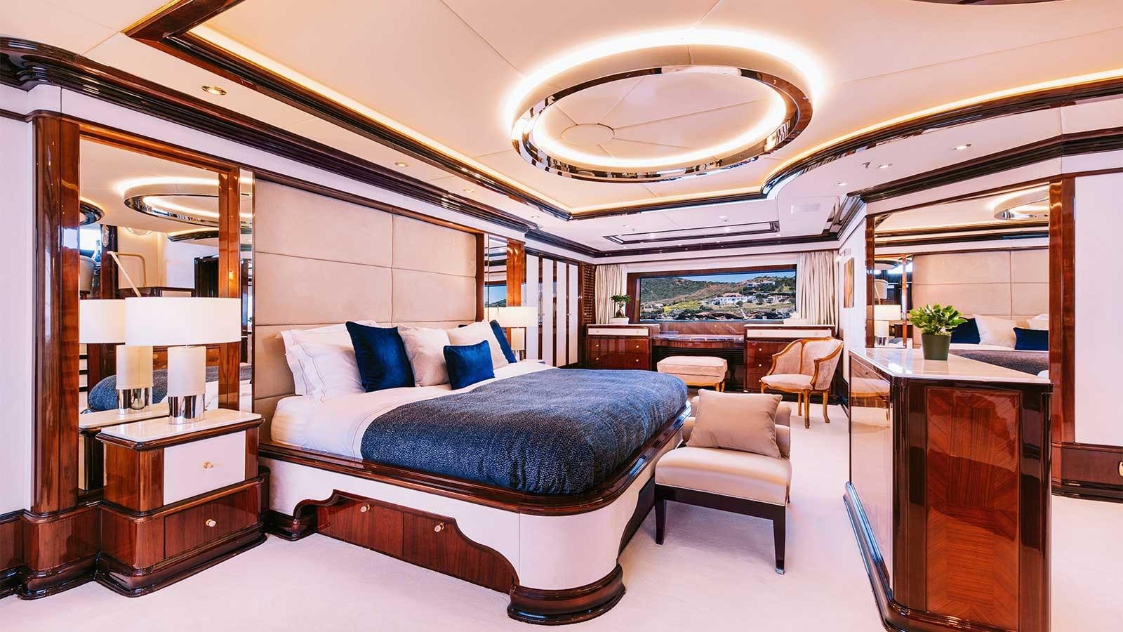 a bedroom with a bed and a desk aboard IDYLLIC Yacht for Charter