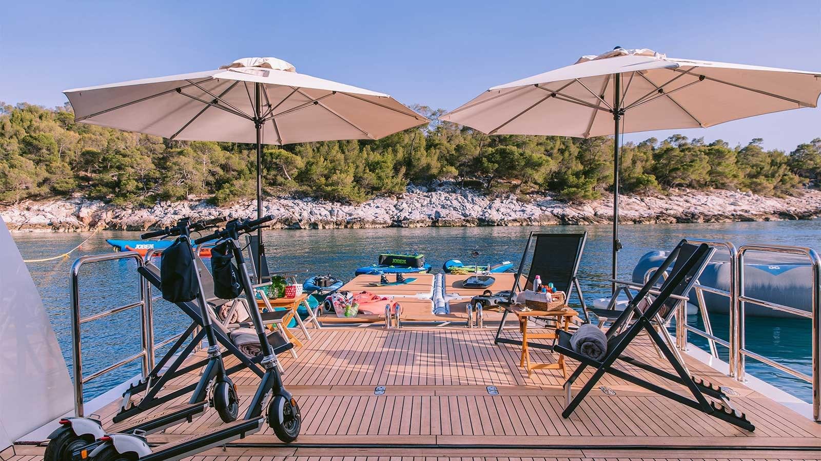 a deck with chairs and umbrellas aboard IDYLLIC Yacht for Charter