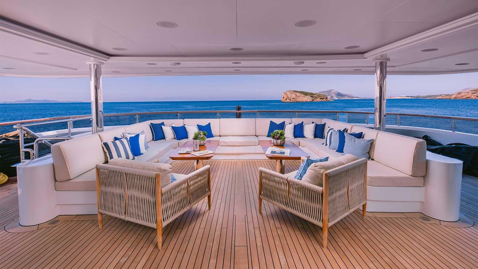 a room with a table chairs and a large body of water aboard IDYLLIC Yacht for Charter
