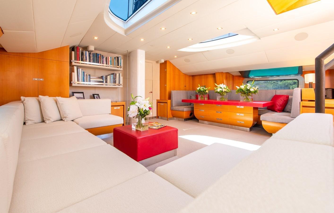 a living room with a white couch and a red coffee table aboard SILVERTIP Yacht for Sale