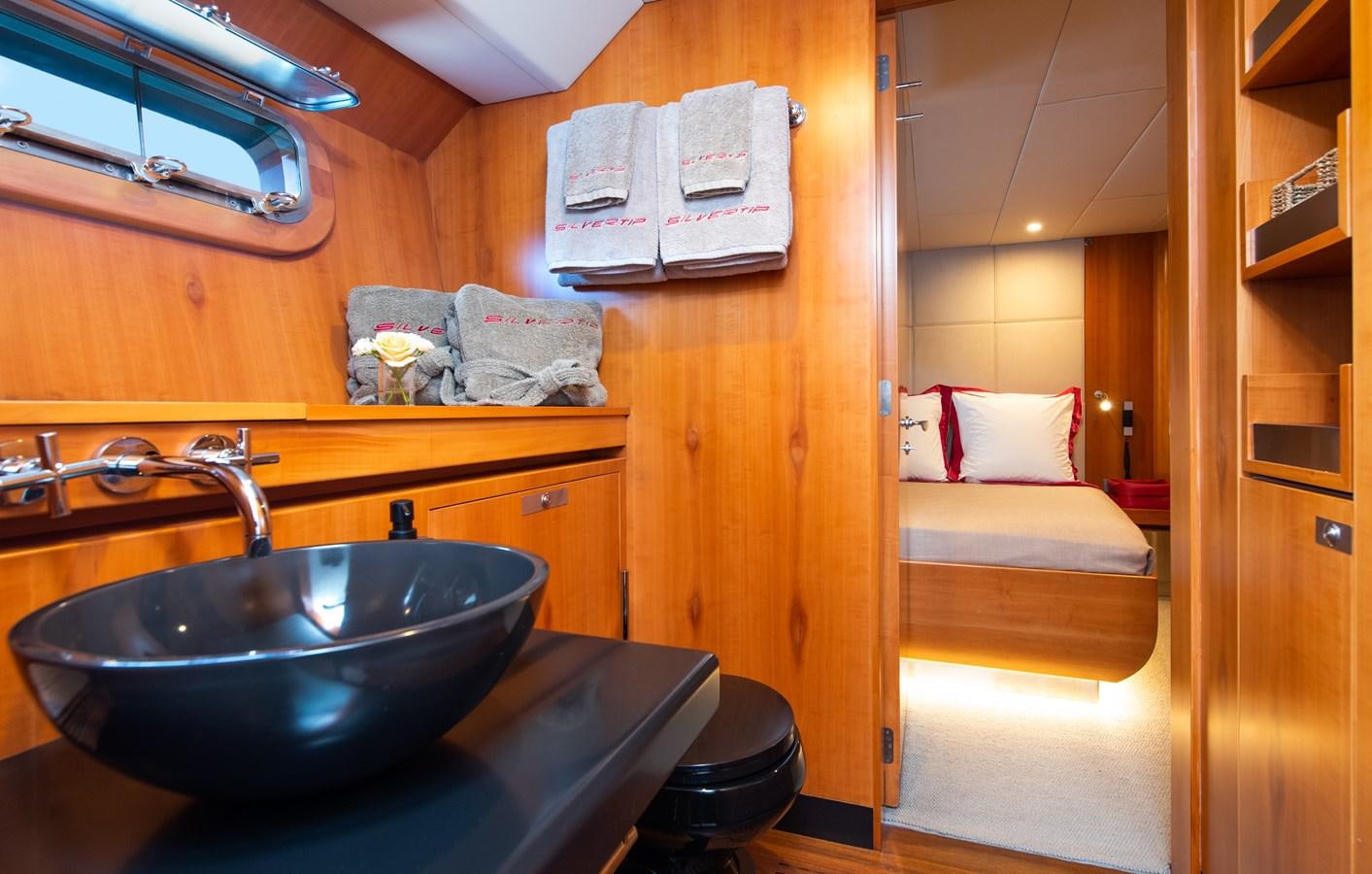 a bathroom with a sink and a bed aboard SILVERTIP Yacht for Sale