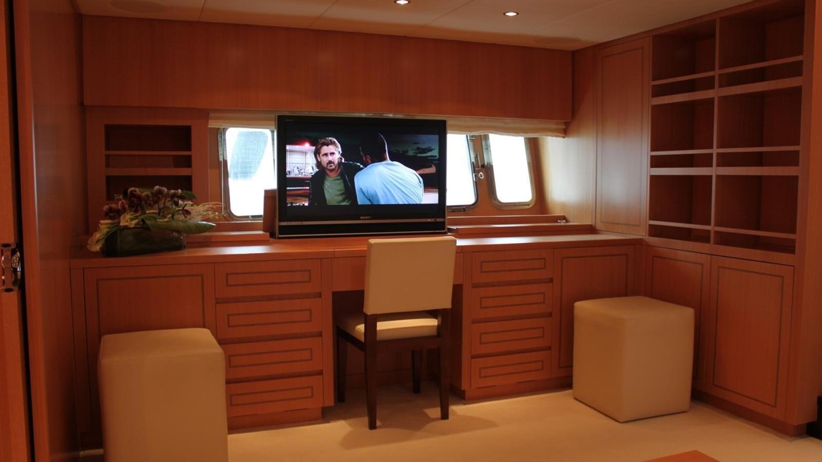 a room with a tv and a chair aboard MAZAG Yacht for Sale