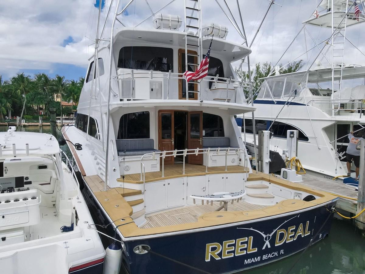 a boat with a flag on the front aboard REEL DEAL Yacht for Sale