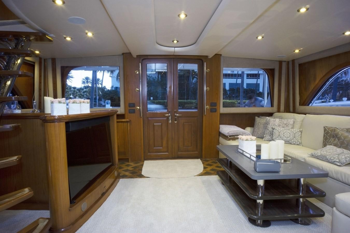 a living room with a couch and a television aboard REEL DEAL Yacht for Sale