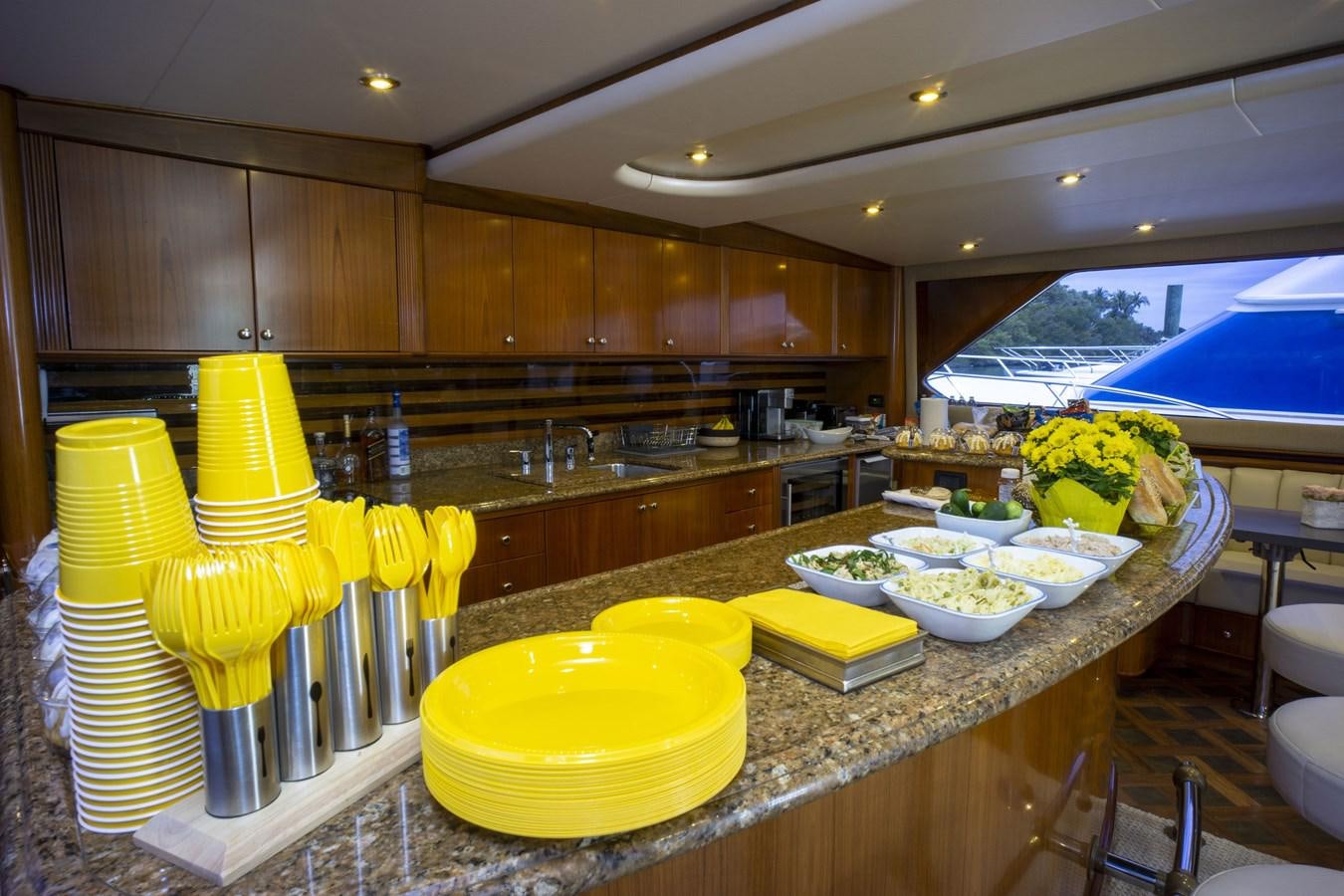 a kitchen with a large island aboard REEL DEAL Yacht for Sale