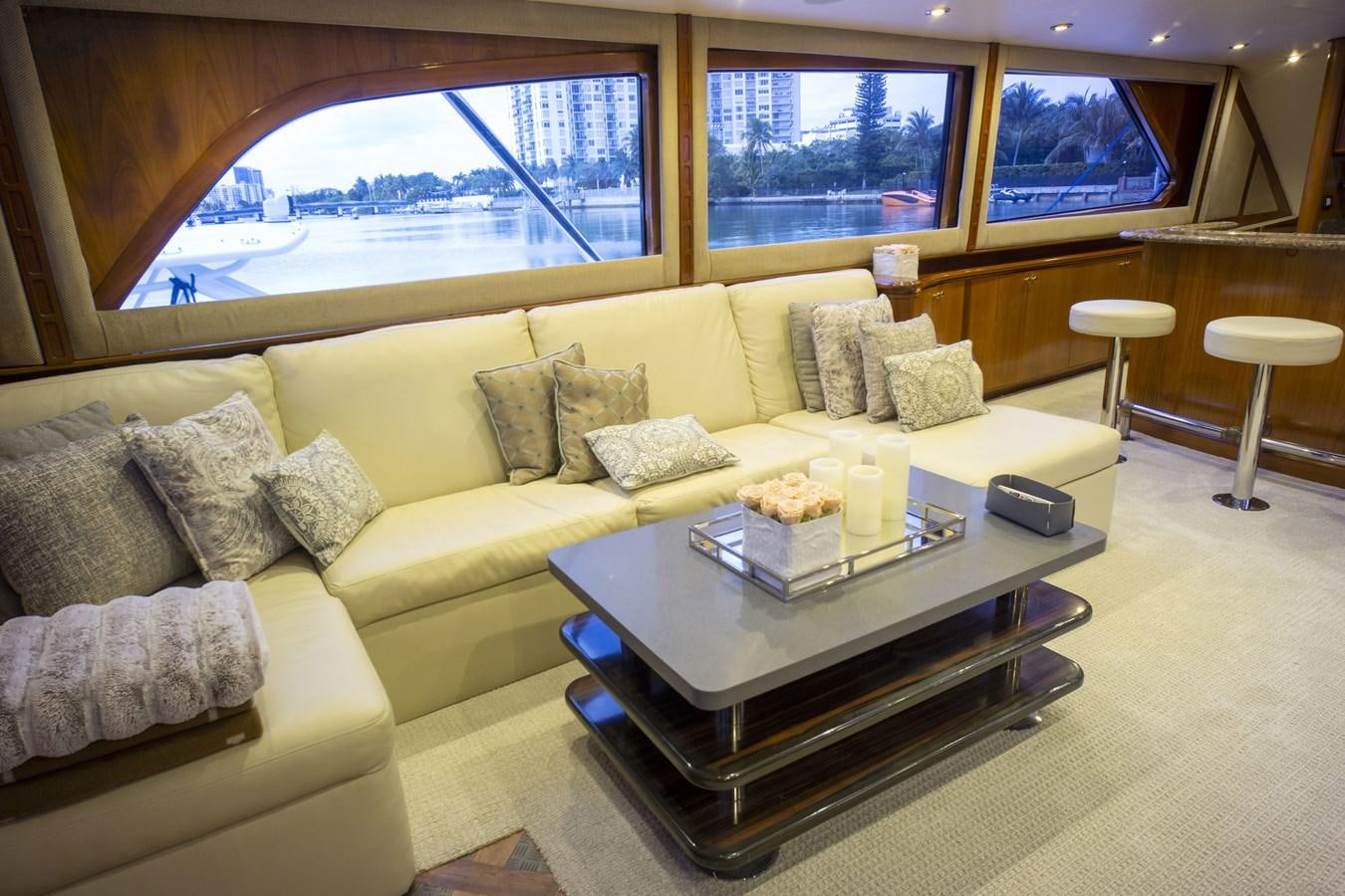 a living room with a couch and coffee table aboard REEL DEAL Yacht for Sale