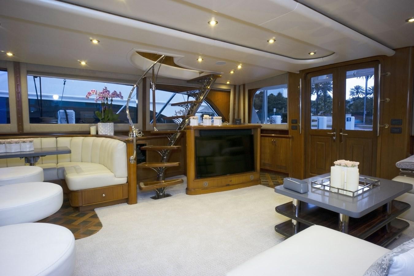 a living room with a fireplace aboard REEL DEAL Yacht for Sale