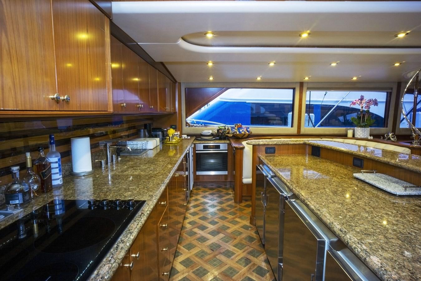 a kitchen with a countertop sink and a bar aboard REEL DEAL Yacht for Sale