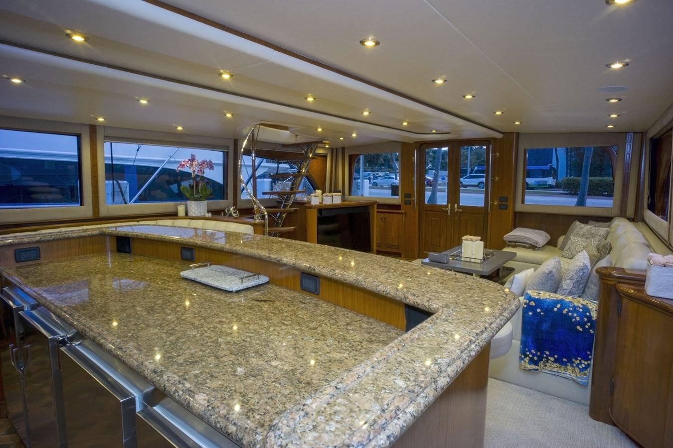 a large kitchen with a large marble counter top aboard REEL DEAL Yacht for Sale