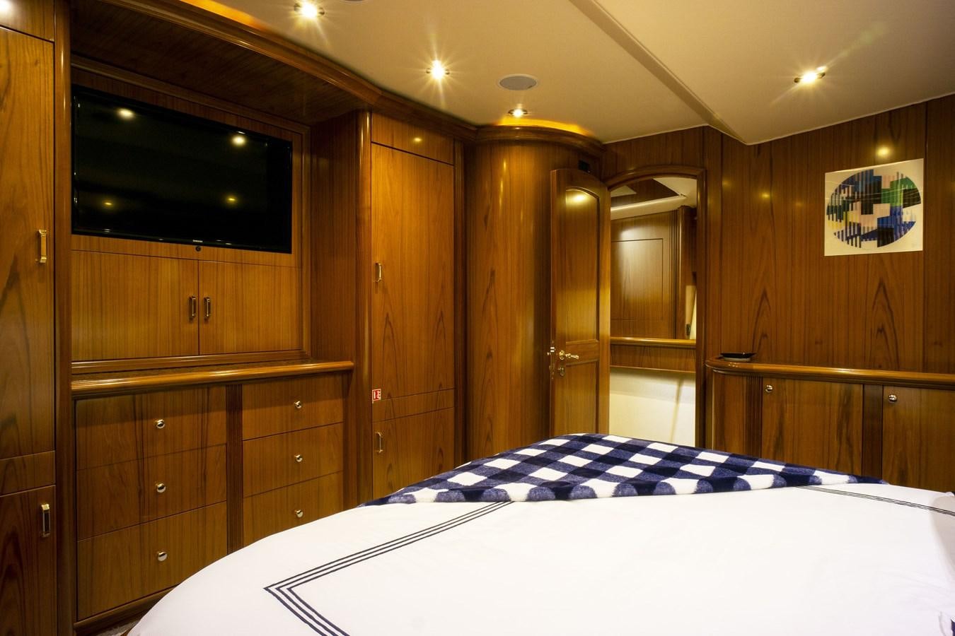 a room with a bed and cabinets aboard REEL DEAL Yacht for Sale