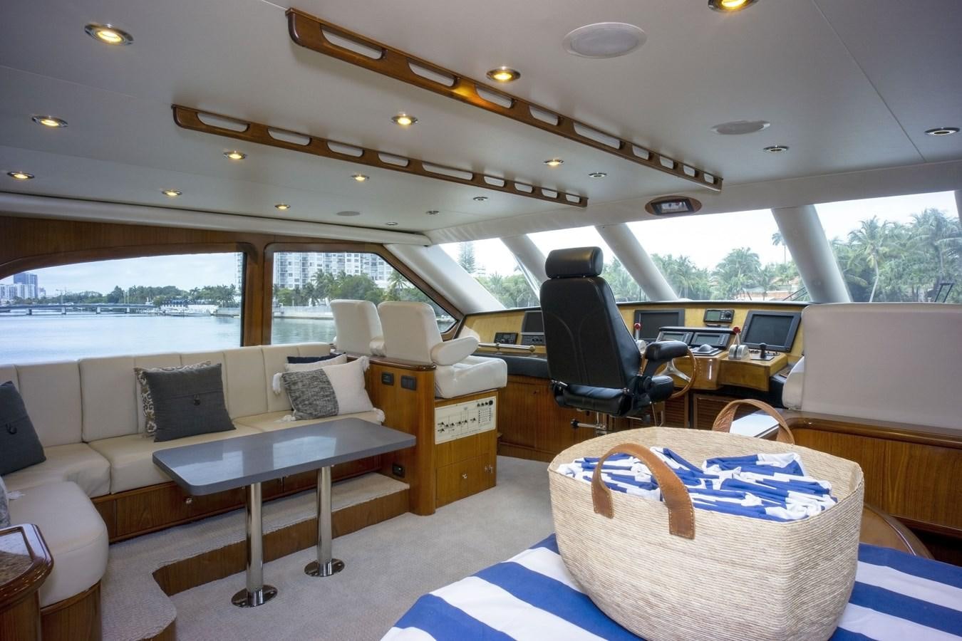 a room with a couch and a table and chairs aboard REEL DEAL Yacht for Sale