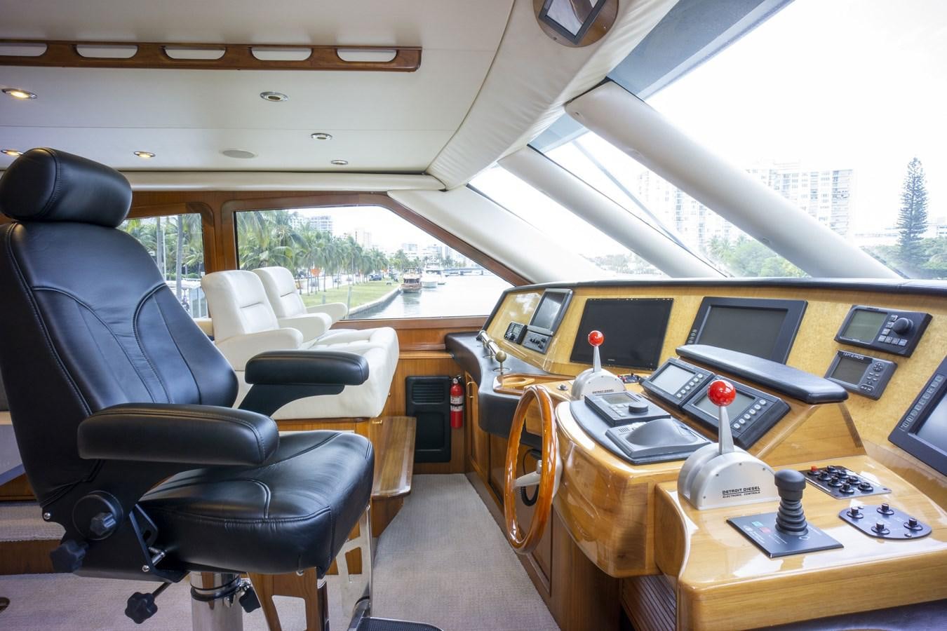 inside of a vehicle with a desk and chairs and a window aboard REEL DEAL Yacht for Sale