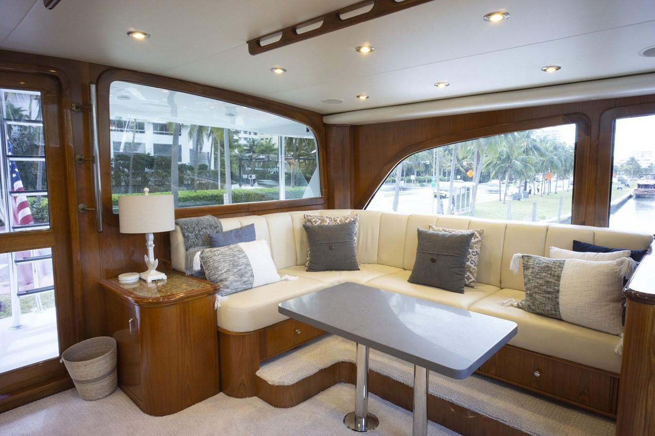 a living room with a couch and a table aboard REEL DEAL Yacht for Sale