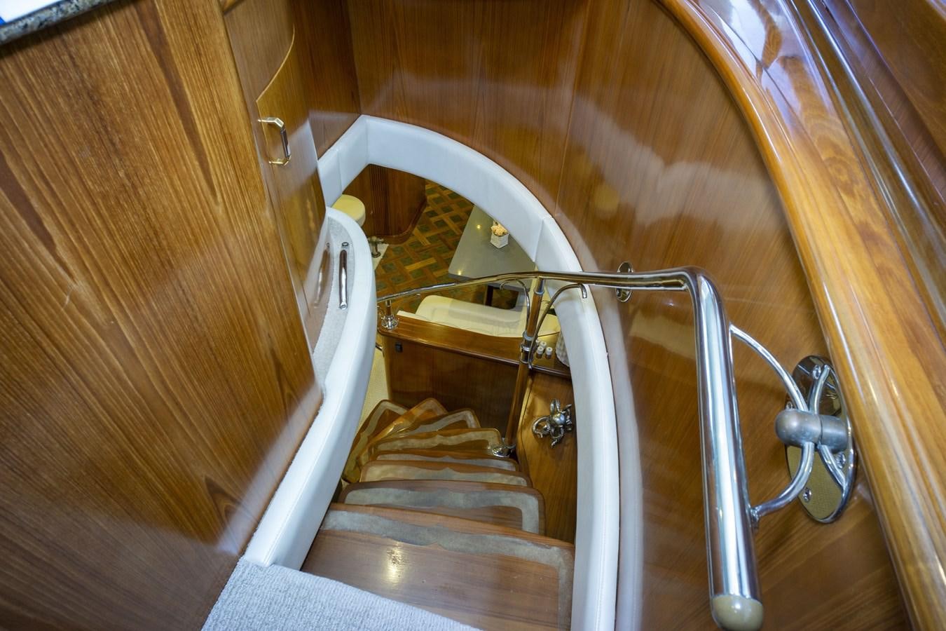 a staircase with a metal railing aboard REEL DEAL Yacht for Sale