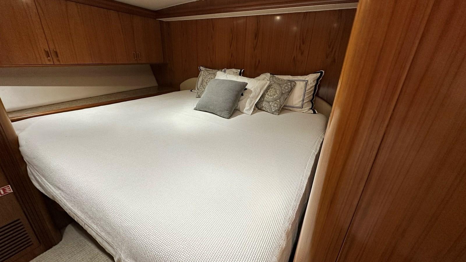 a bed with white sheets aboard REEL DEAL Yacht for Sale