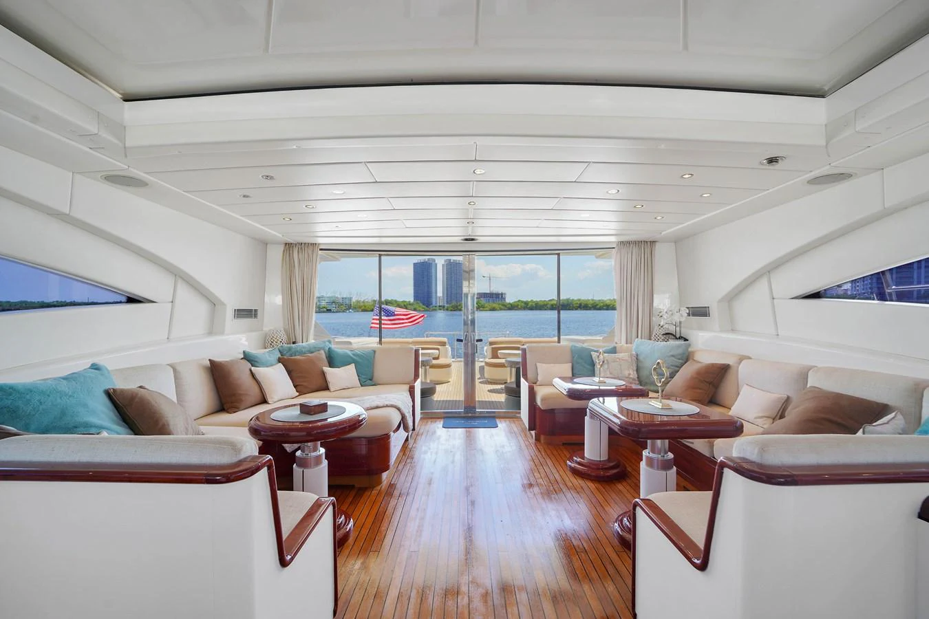 a living room with a large window aboard 108' MANGUSTA 2002 Yacht for Sale