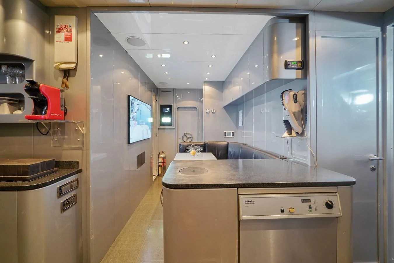 a kitchen with a counter and cabinets aboard 108' MANGUSTA 2002 Yacht for Sale