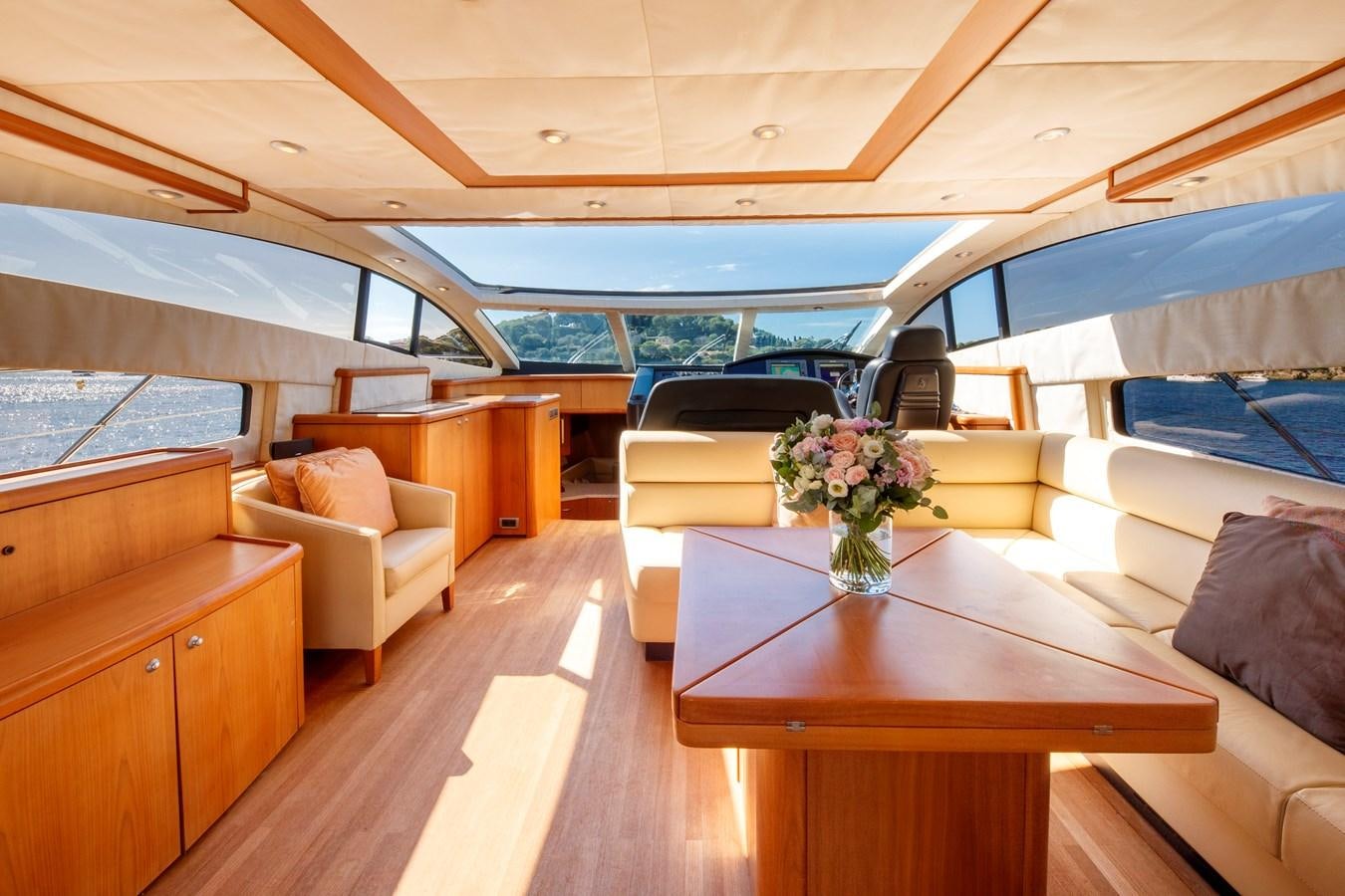 a boat with a table and chairs aboard NUTS Yacht for Sale