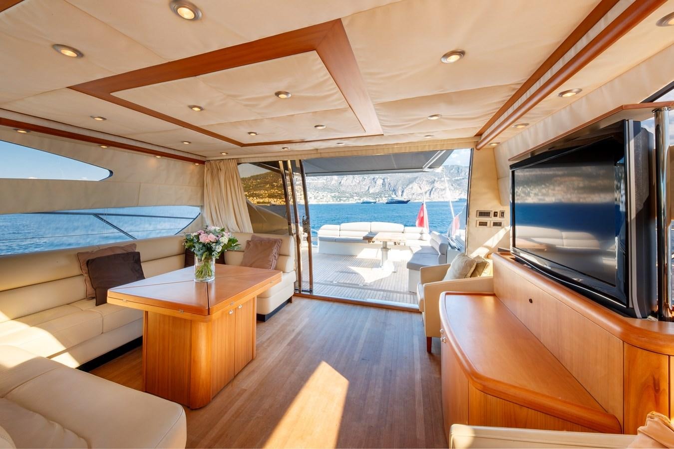 a room with a tv and furniture aboard NUTS Yacht for Sale