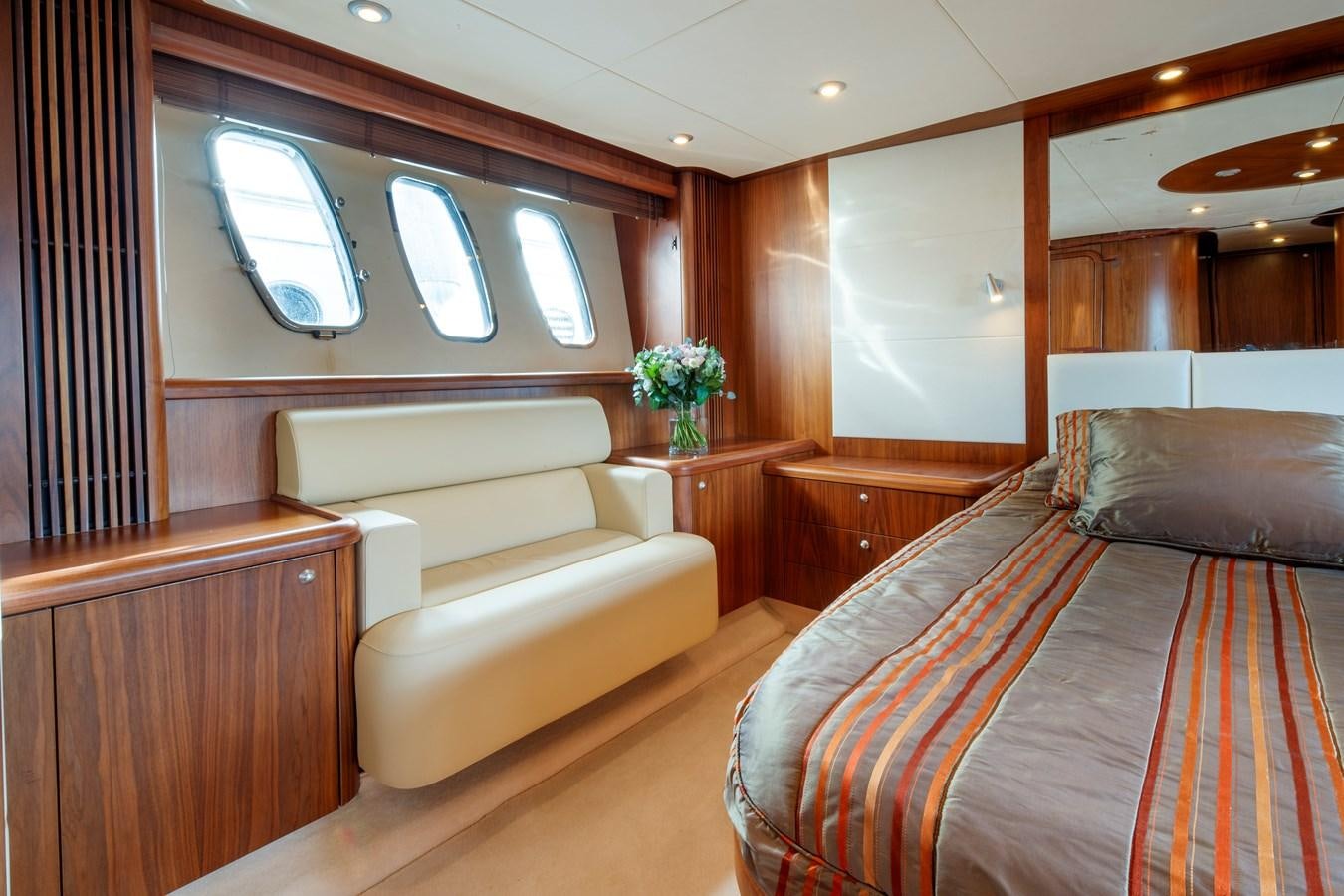a room with a bed and a couch aboard NUTS Yacht for Sale