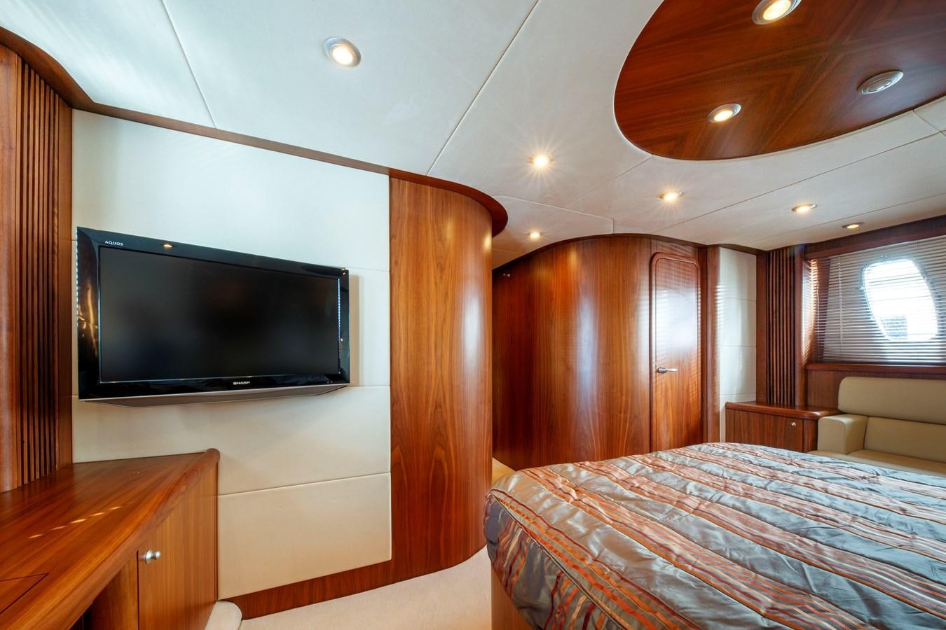 a bedroom with a tv and a bed aboard NUTS Yacht for Sale