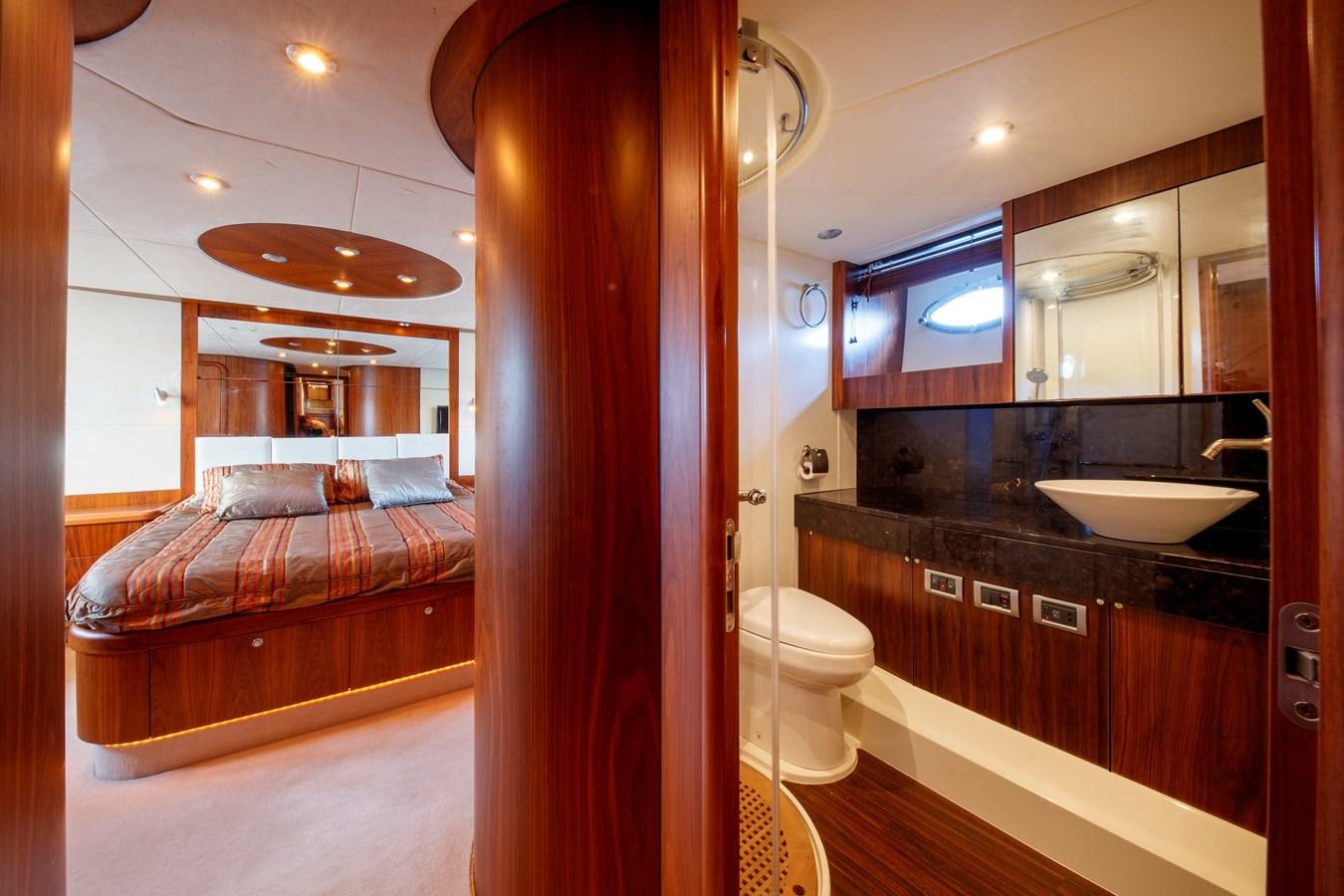 a bathroom with a bed and a sink aboard NUTS Yacht for Sale