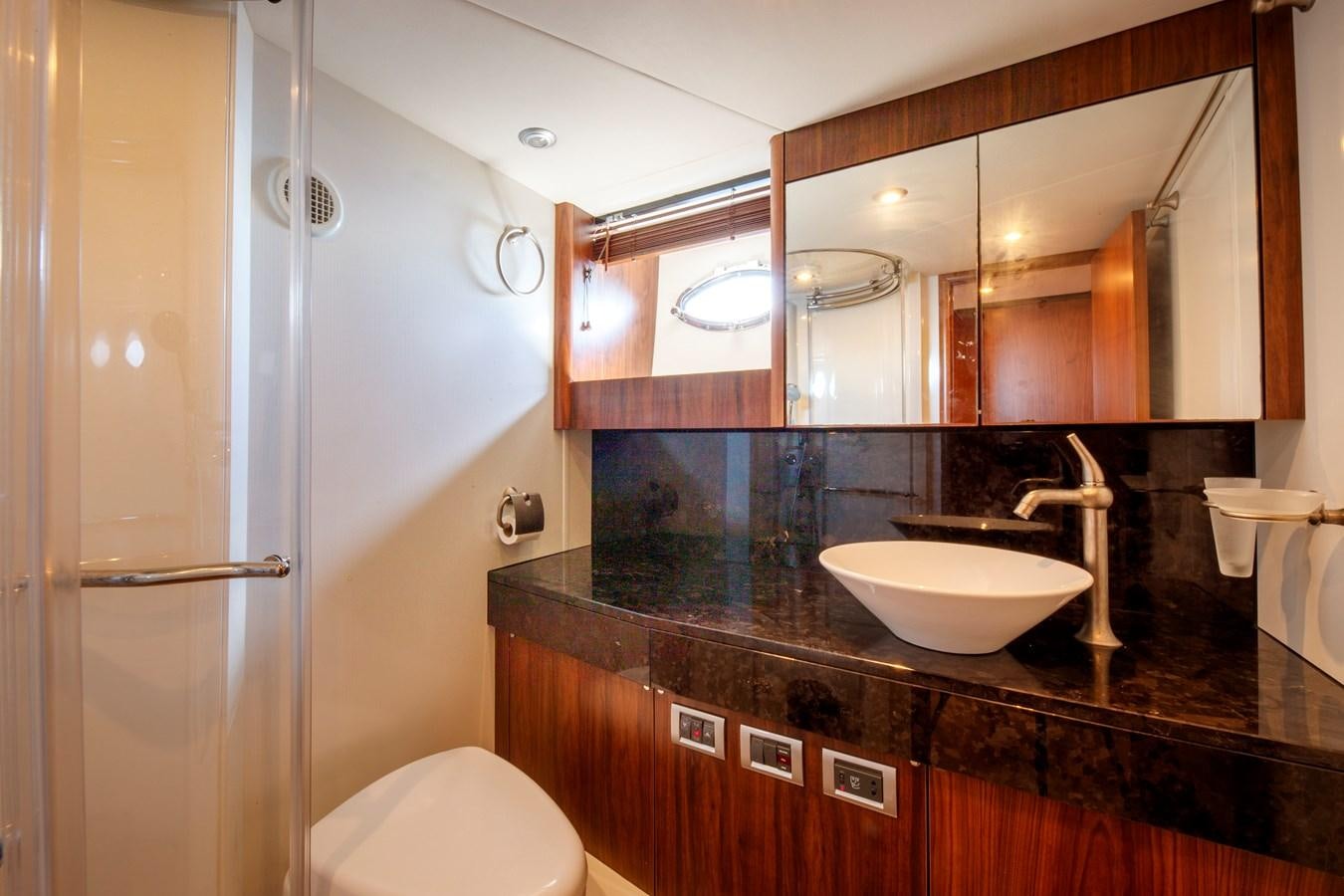 a bathroom with a sink and a mirror aboard NUTS Yacht for Sale