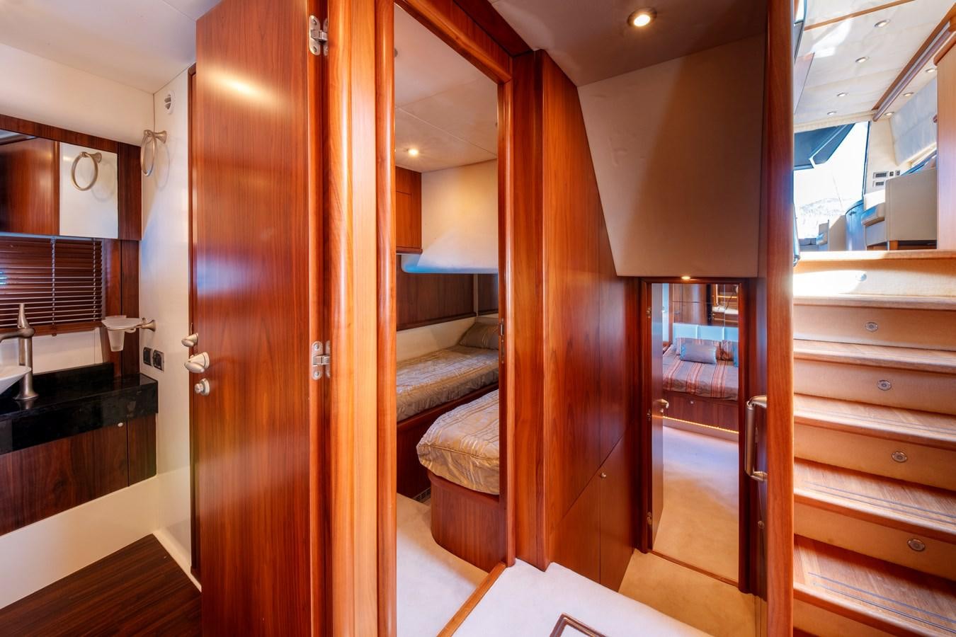 a room with a wood door and a bed aboard NUTS Yacht for Sale