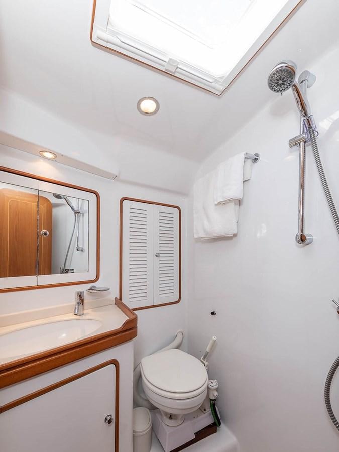 a bathroom with a toilet and sink aboard VENTUROUS Yacht for Sale