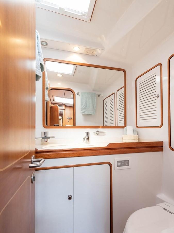 a bathroom with a mirror aboard VENTUROUS Yacht for Sale