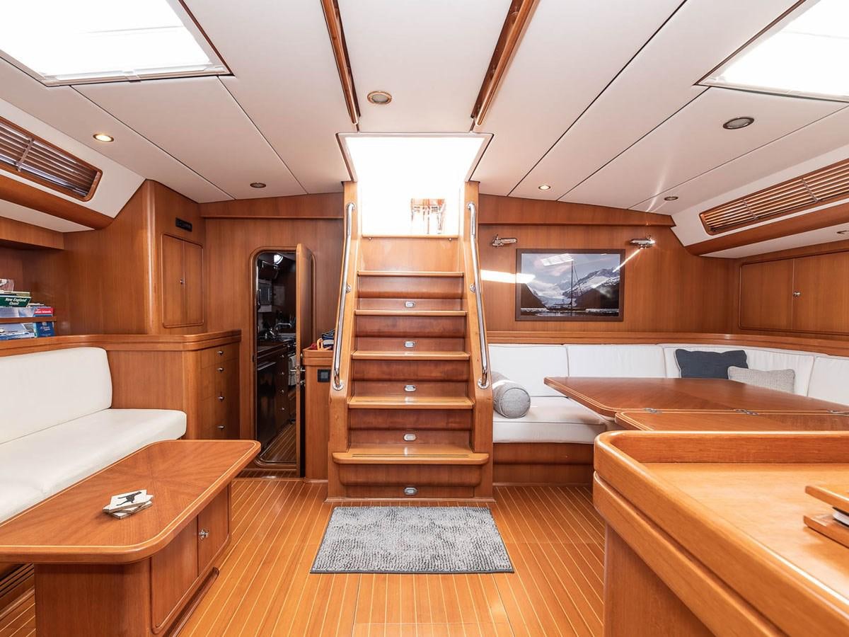 a room with wooden floors and a staircase aboard VENTUROUS Yacht for Sale