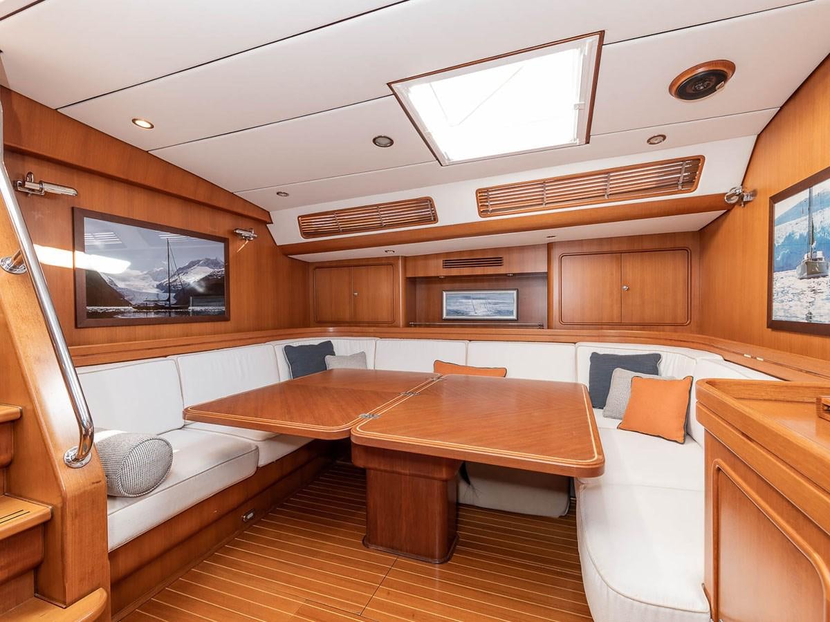 a room with a bed and a desk aboard VENTUROUS Yacht for Sale