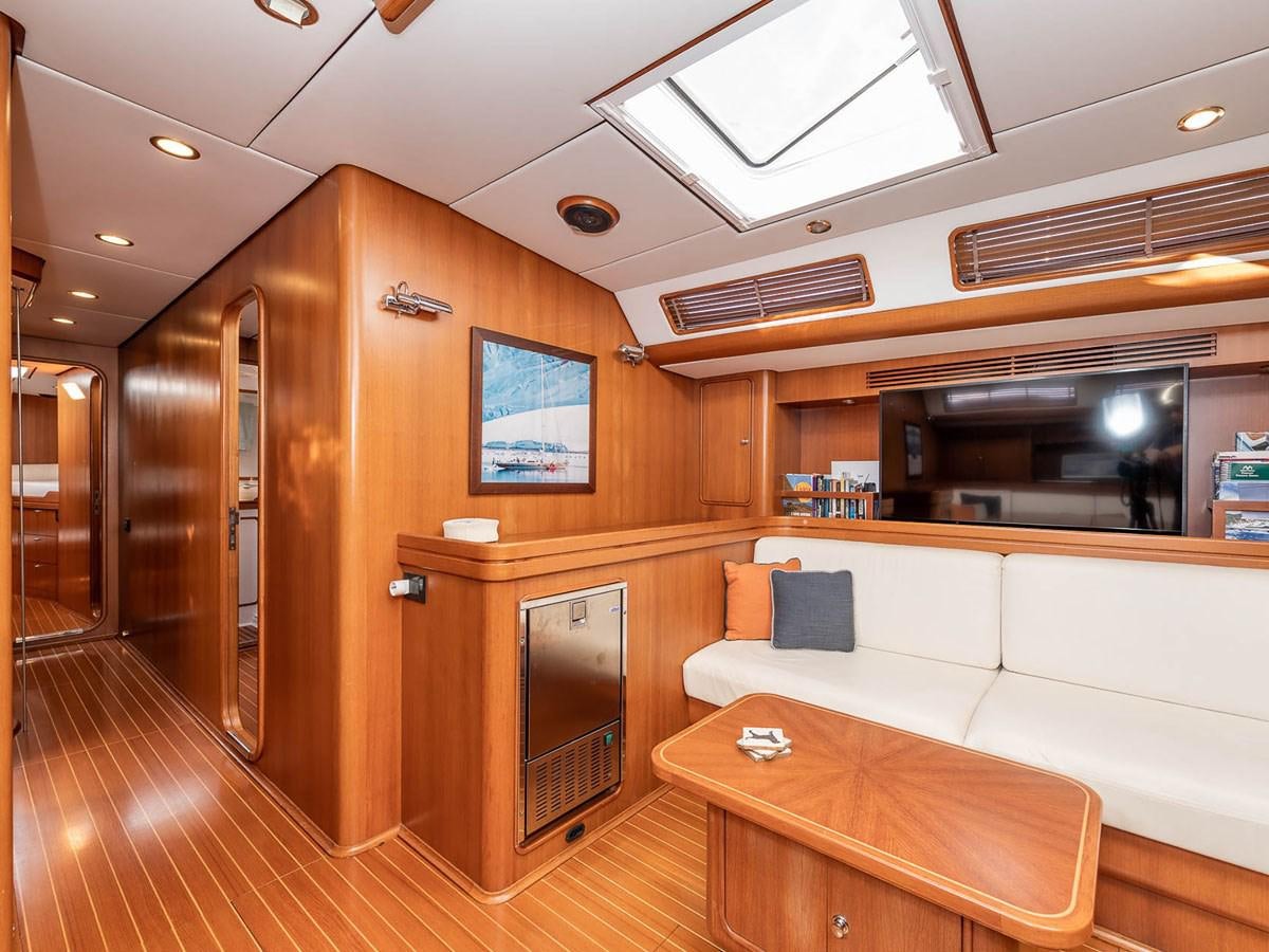 a room with a couch and a table aboard VENTUROUS Yacht for Sale