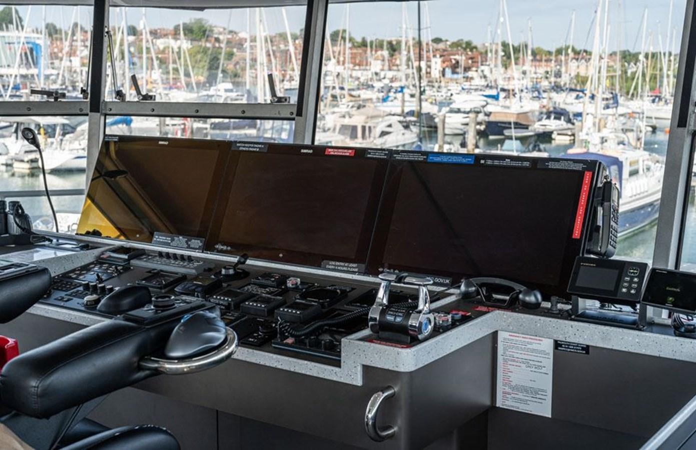 a desk with a computer and a window overlooking a city aboard GREY WOLF Yacht for Sale