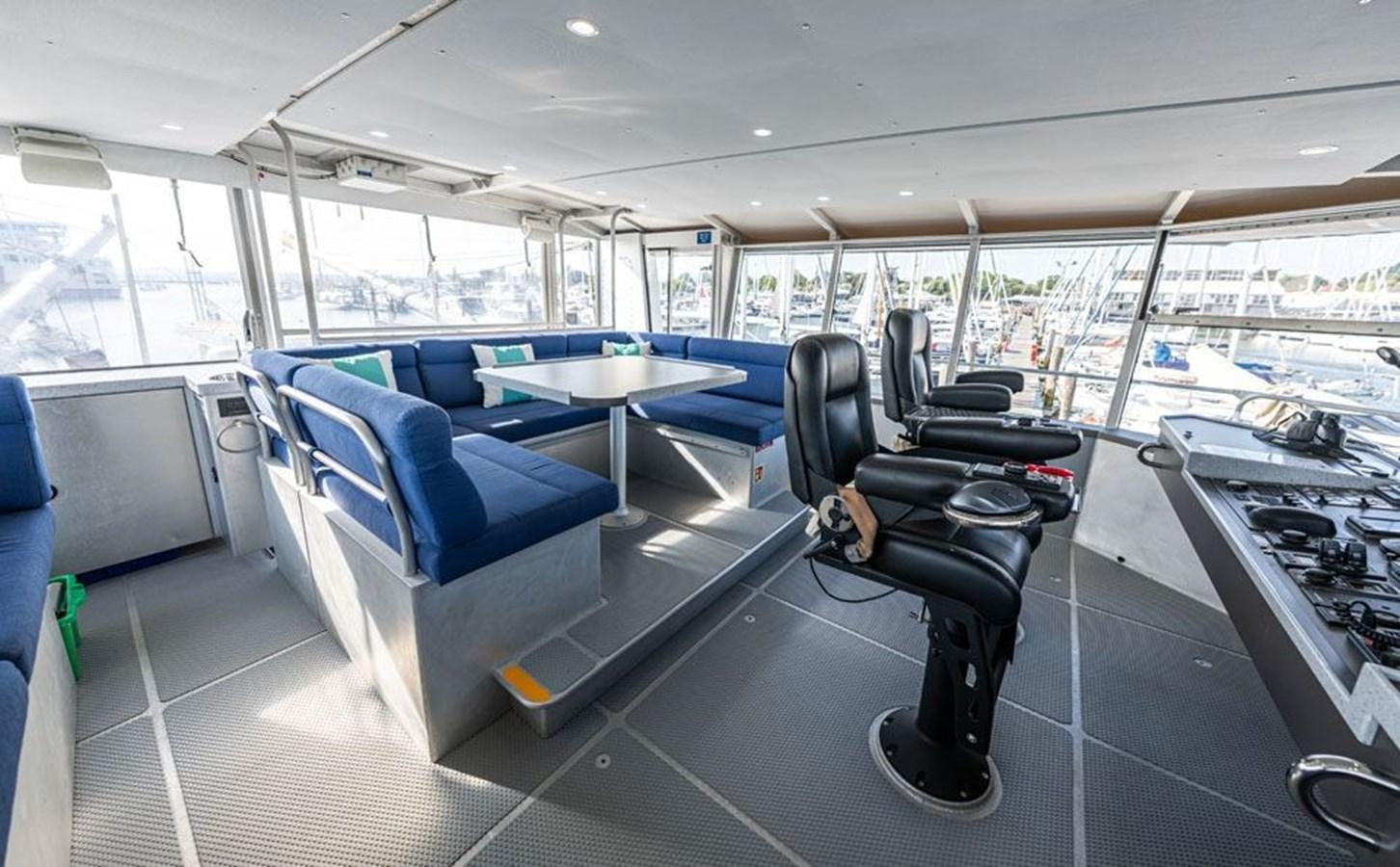 a room with a table and chairs aboard GREY WOLF Yacht for Sale