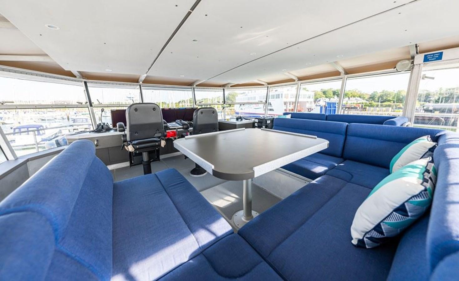 a boat with a table and chairs aboard GREY WOLF Yacht for Sale