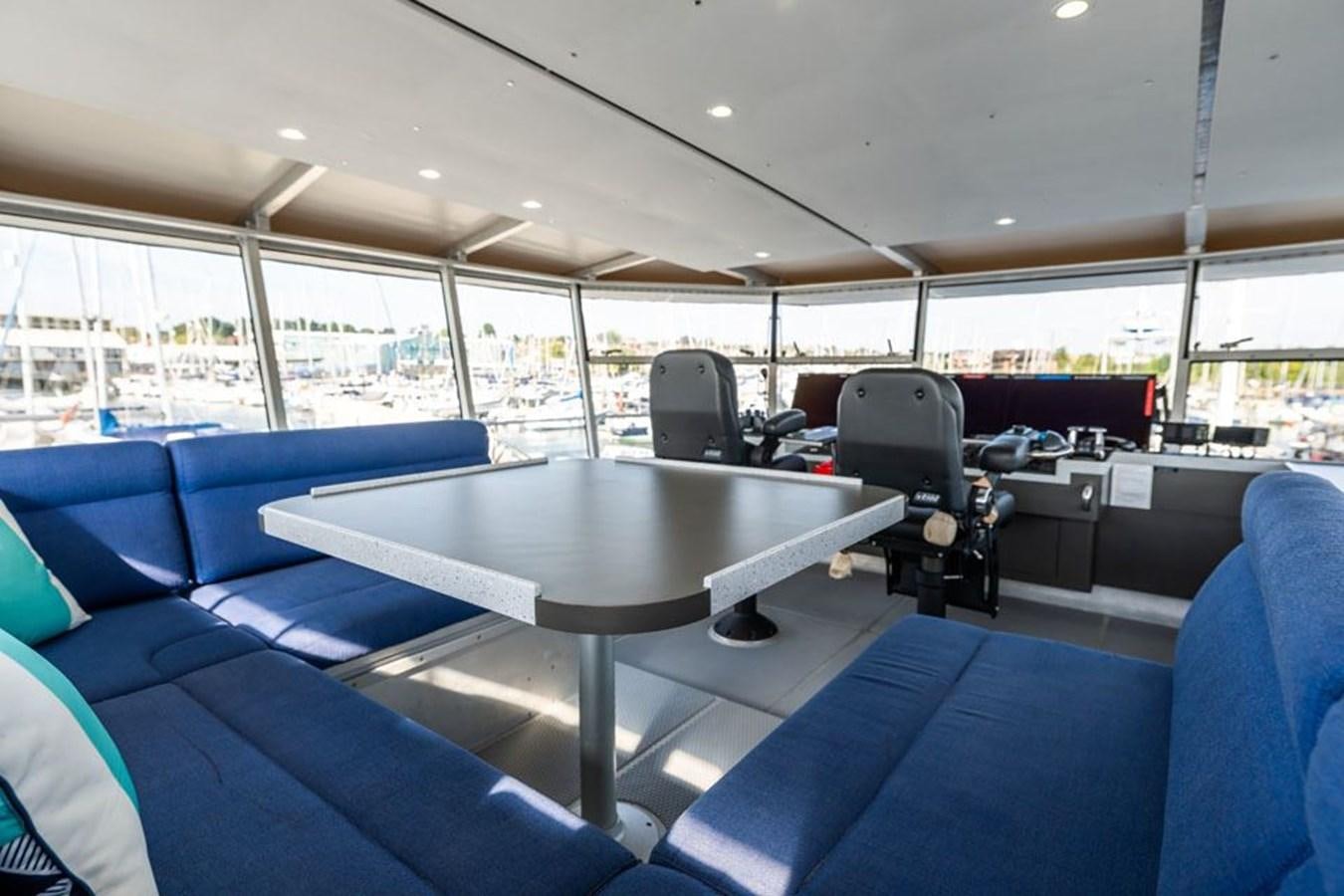 a large room with a table and chairs aboard GREY WOLF Yacht for Sale